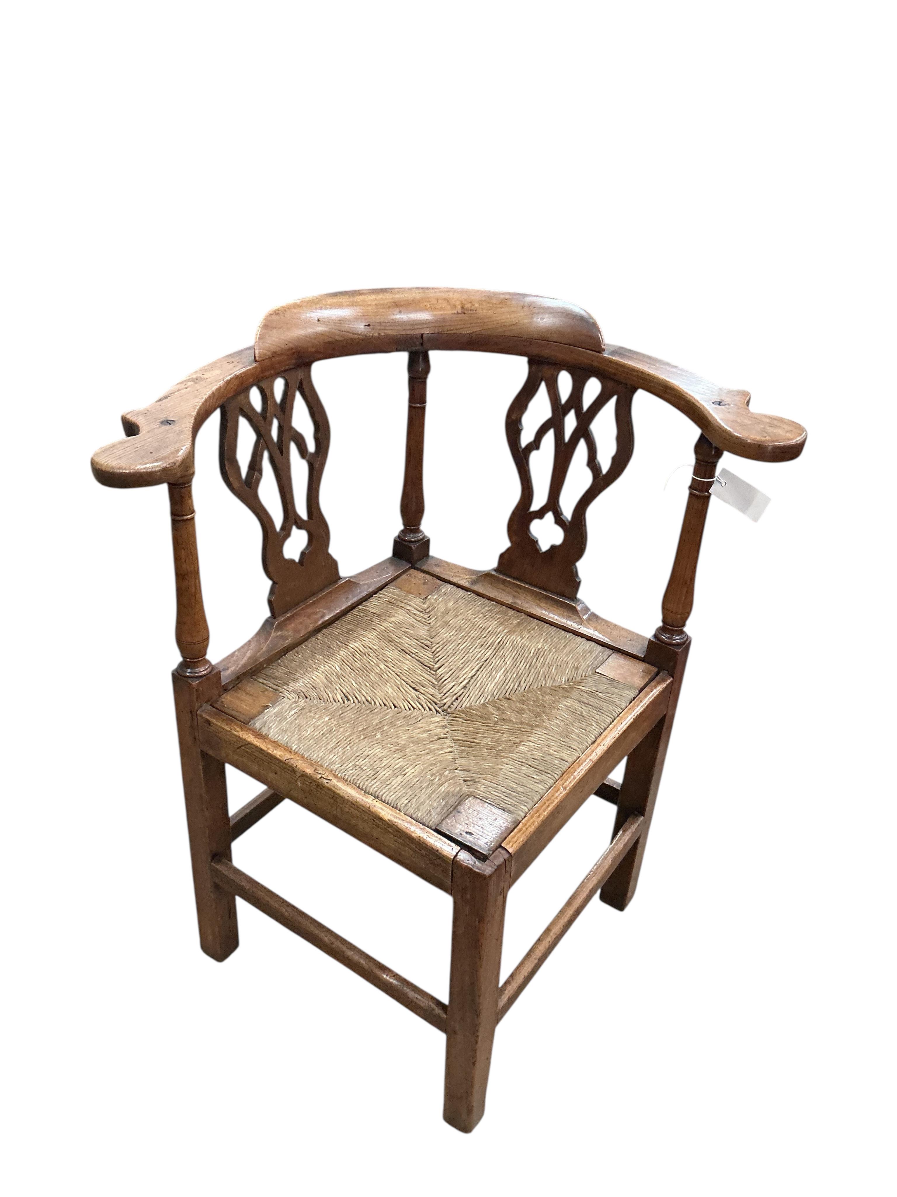 A George III oak corner elbow chair, width 75cm, depth 63cm, height 86cm